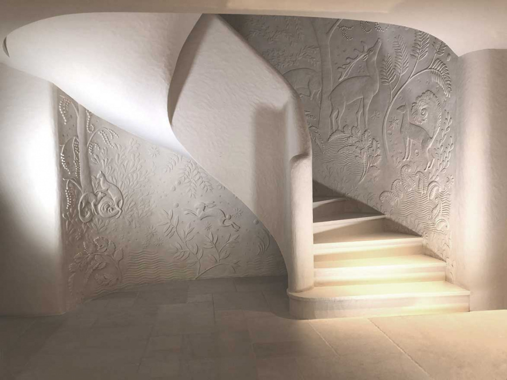 at lanvin shop in paris, the staircase is ornated with low relief sculpted walls