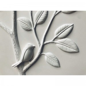 détail d'un oiseau sur une branche de citronnier sculpture oiseau sur une branche de citronnier en bas-relief